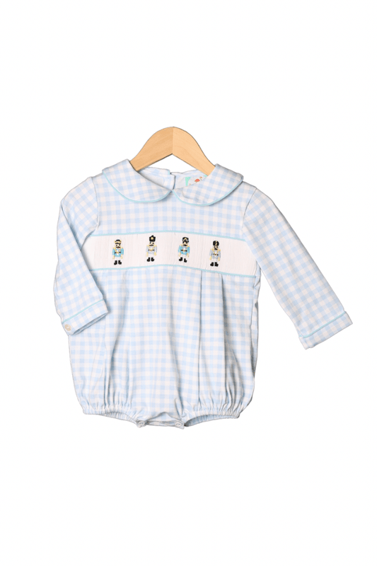 https://thesmockedflamingo.com/cdn/shop/files/the-smocked-flamingo-apparel-accessories-smocked-toy-soldier-blue-gingham-bubble-39911911162086_533x.png?v=1697145470