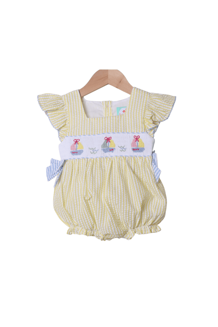 The Smocked Flamingo Smocked Sailboat Blue/Yellow Ruffle Bubble